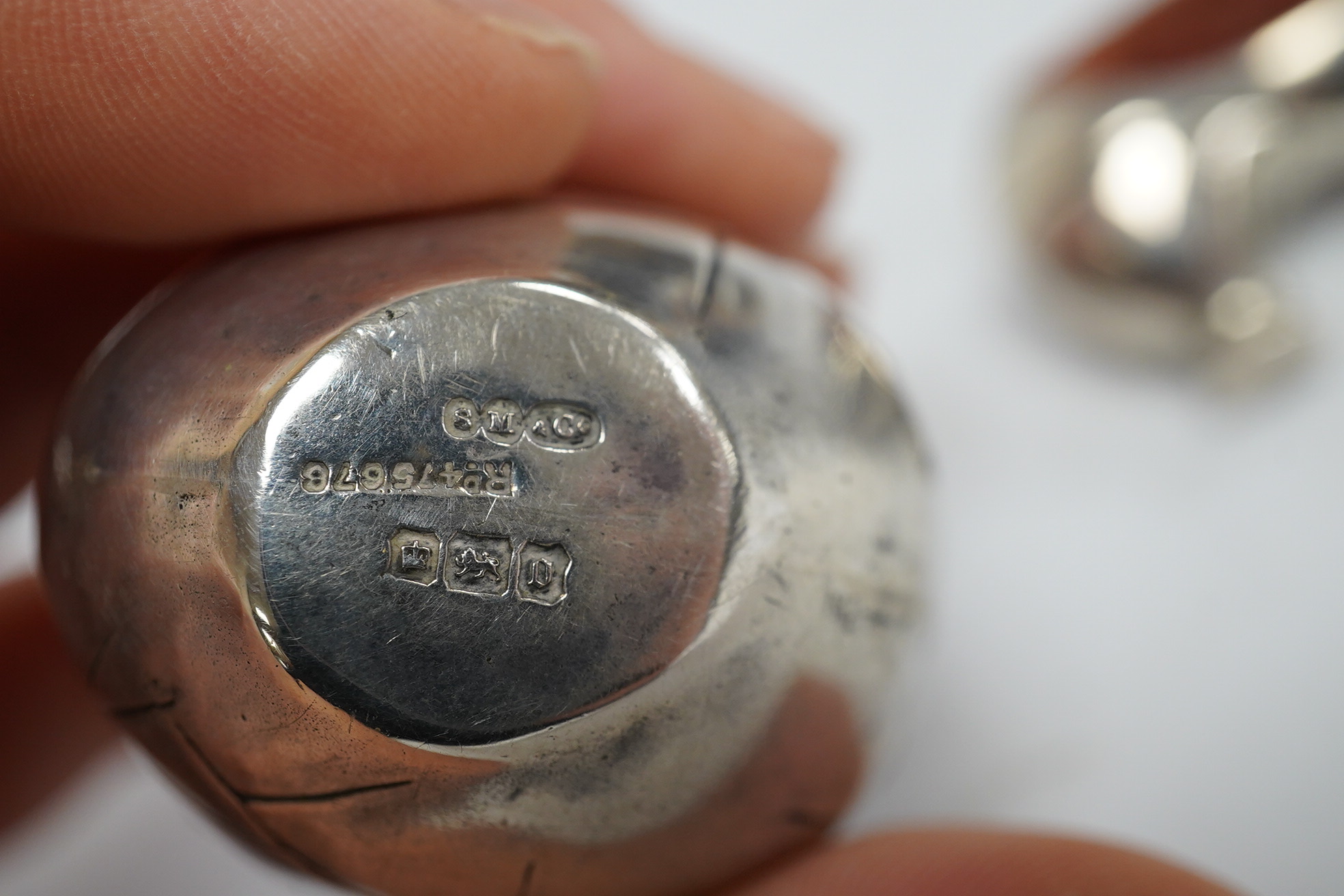 An Edwardian novelty silver pin cushion, modelled as a hatching chick, by Sampson Mordan & Co, Sheffield, 1906, height 43mm (hole), together with a late Victorian shoe pin cushion, by Adie & Lovekin, Birmingham, 1892, Co